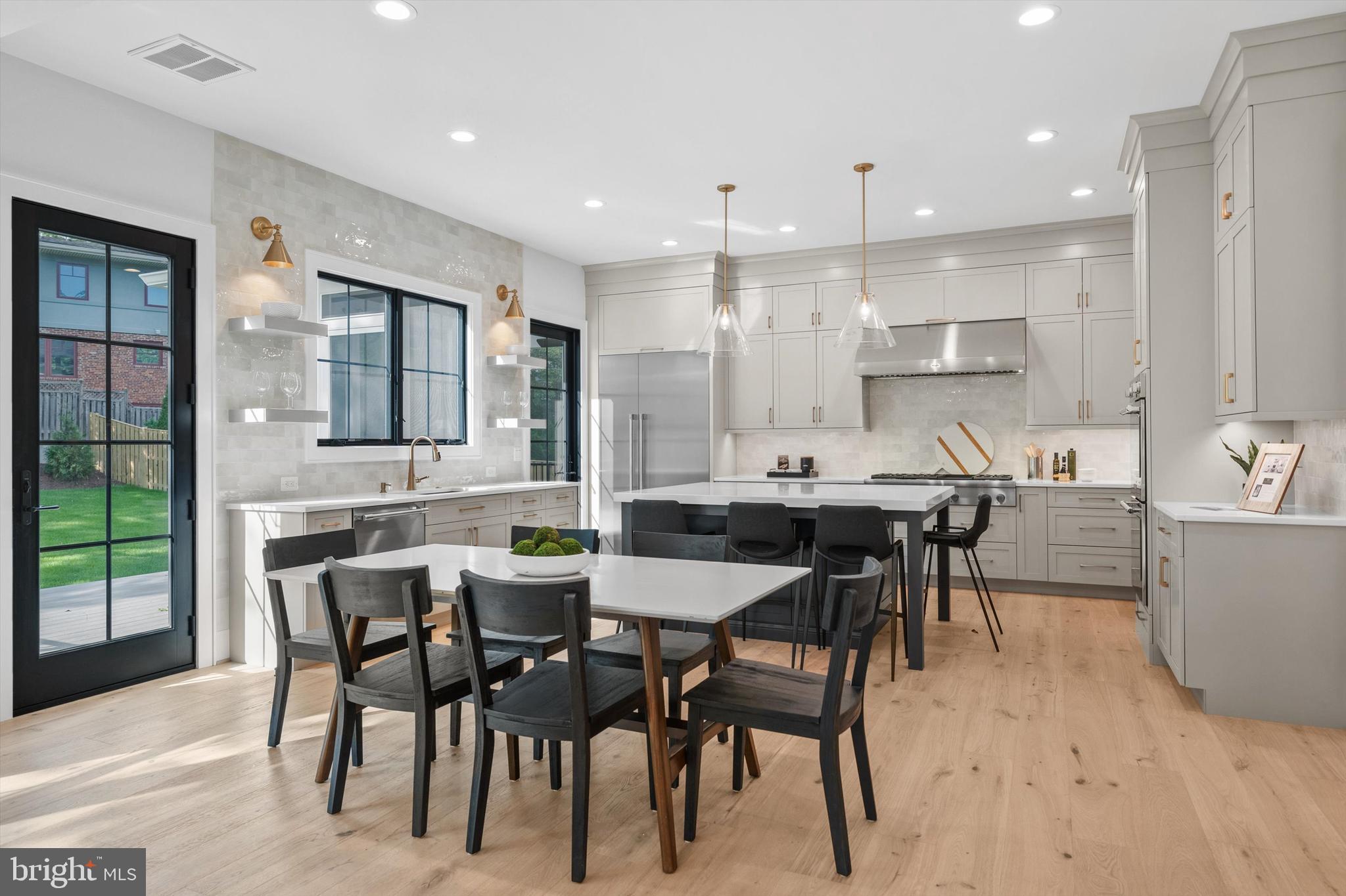 6807 29th Street North Arlington, VA 22213 - Photo 12 of 36 a dining room with kitchen island furniture a chandelier kitchen view and a sink
