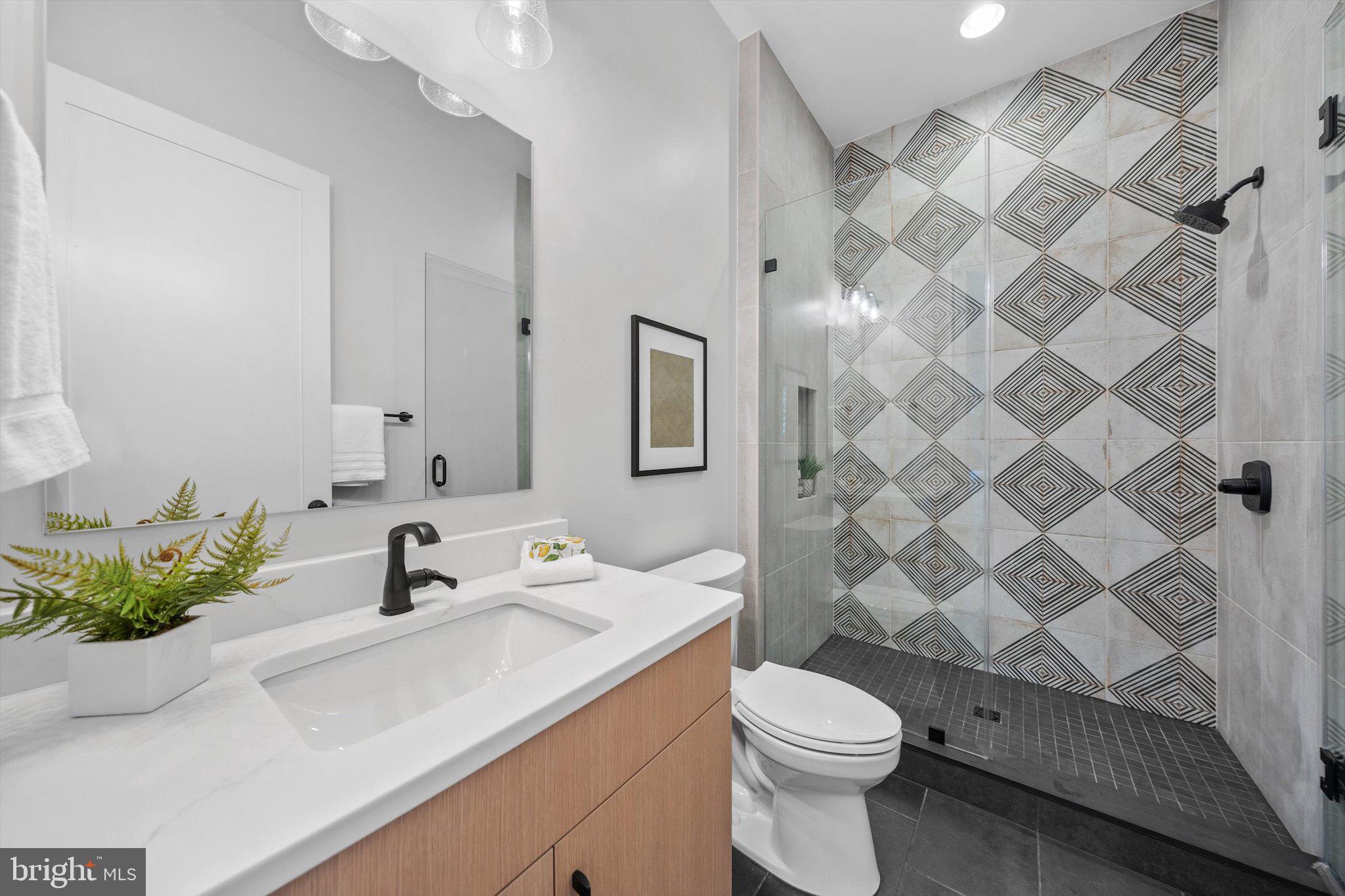 6807 29th Street North Arlington, VA 22213 - Photo 19 of 36 a bathroom with a sink toilet and shower
