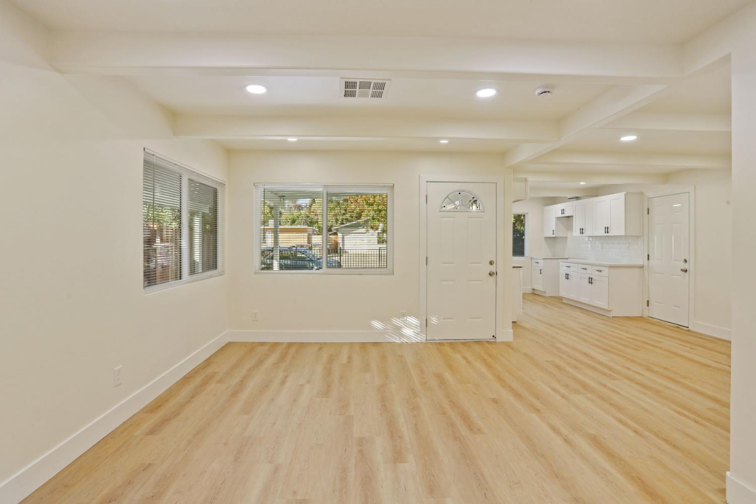 2036 Del Rio Drive Stockton, CA 95204 - Photo 12 of 30 a view of empty room with wooden floor and windows