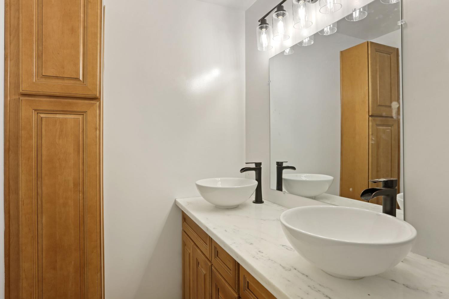 2036 Del Rio Drive Stockton, CA 95204 - Photo 25 of 30 a bathroom with a granite countertop sink and a mirror