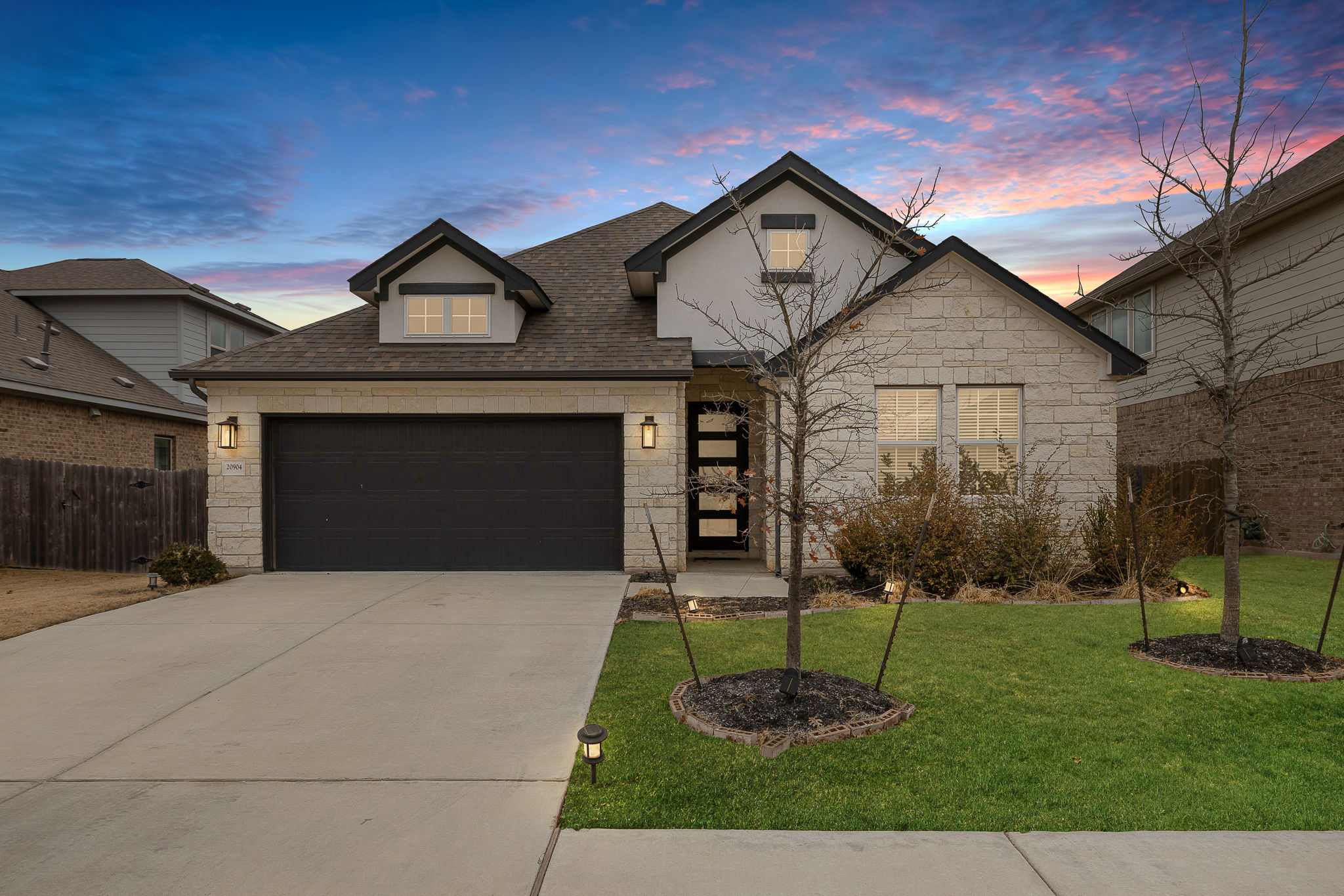 a front view of a house with a yard and garage