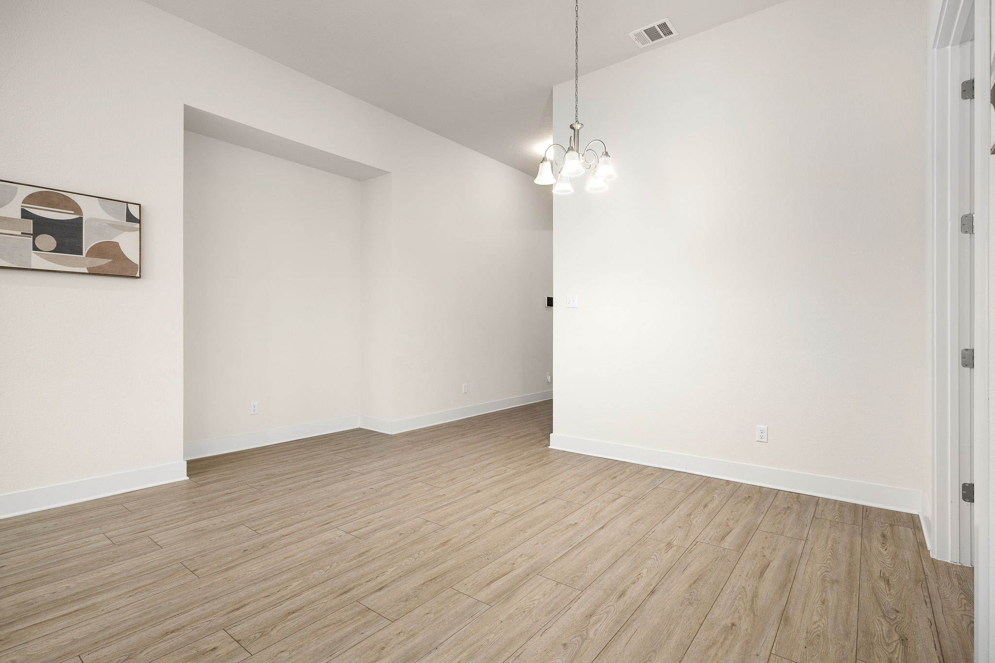 20904 Carries Ranch Road Pflugerville, TX 78660 - Photo 6 of 33 an empty room with wooden floor and ceiling fan
