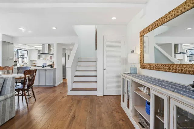 a open kitchen with stainless steel appliances granite countertop a stove and wooden floor