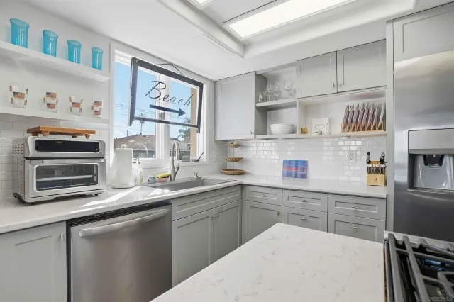 a kitchen with stainless steel appliances a sink and cabinets