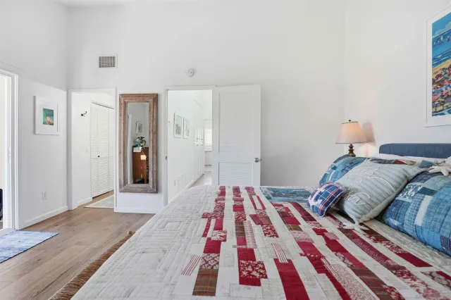 a bedroom with a bed and wooden floor