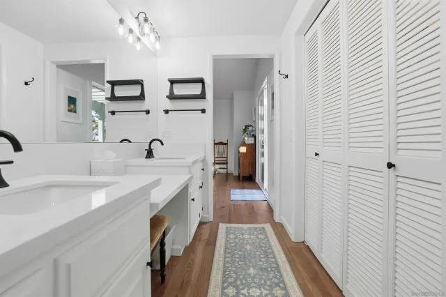 a view of a bathroom with a sink and mirror