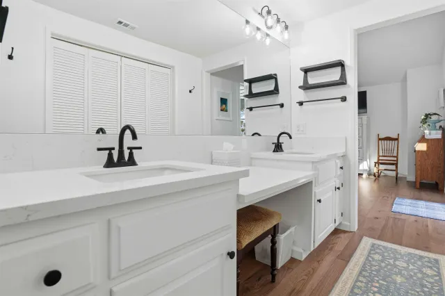 a kitchen with a sink cabinets and wooden floor