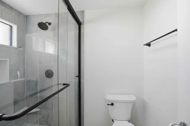 a bathroom with a shower and a toilet