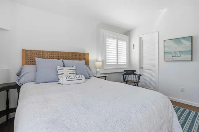 a bedroom with a bed and a table