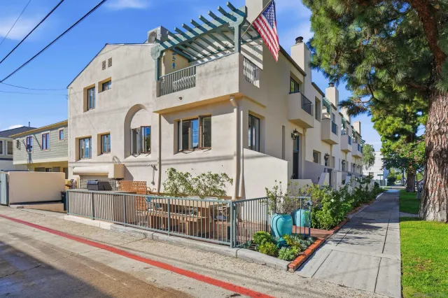 a front view of a building with a garden