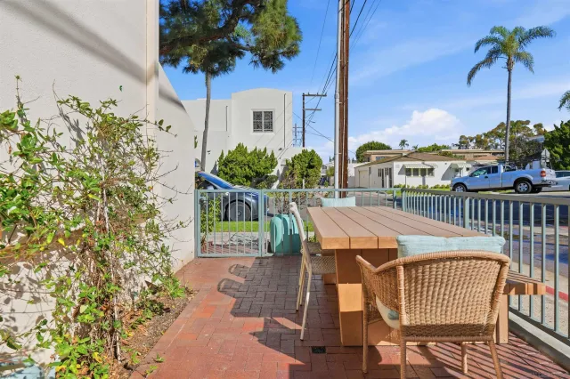 a view of a patio with table and chairs and potted plants