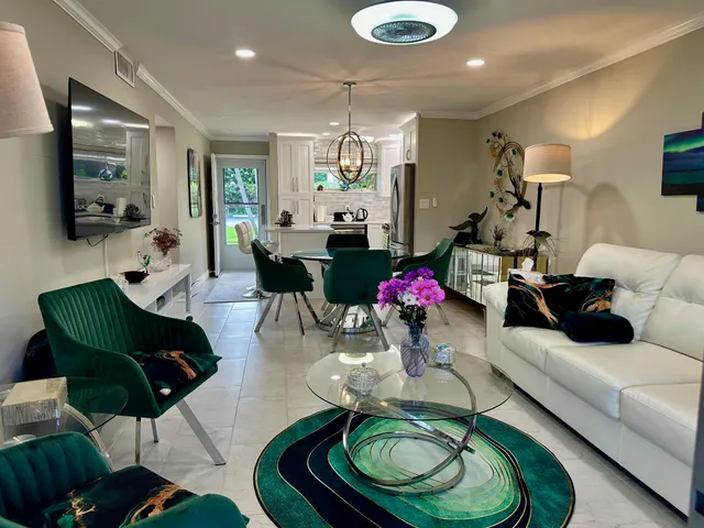 a living room with furniture and a chandelier