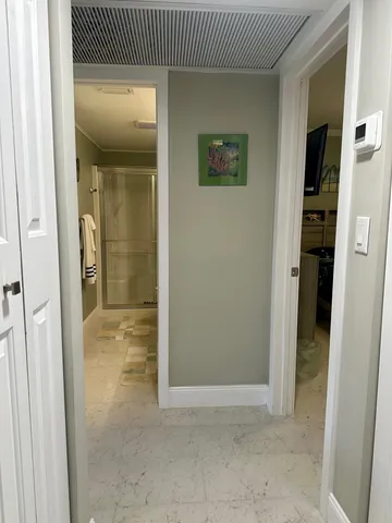 a bedroom with a bed and large windows