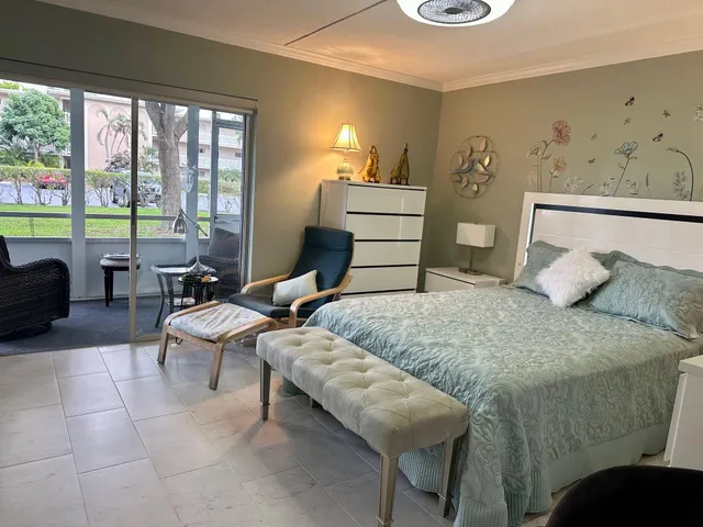 a bedroom with a bed and a television