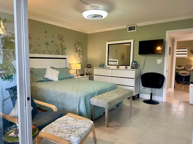 a bed sitting in a bedroom next to a window