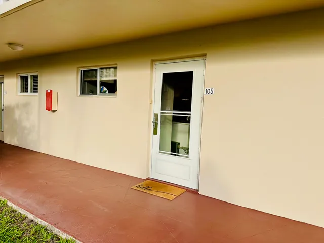 a front view of a building with garden