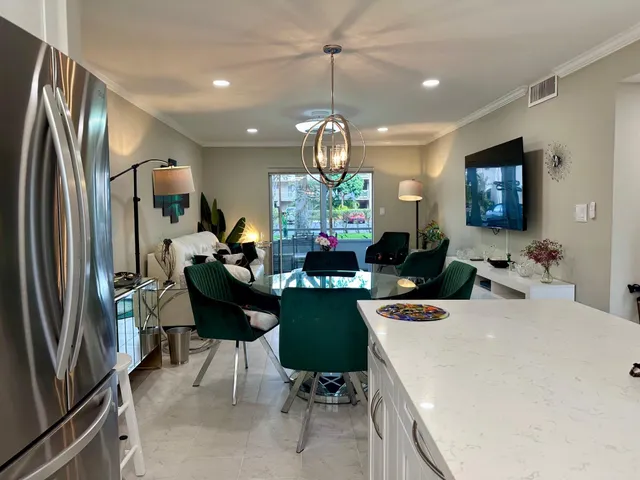 a kitchen with a table chairs refrigerator and microwave