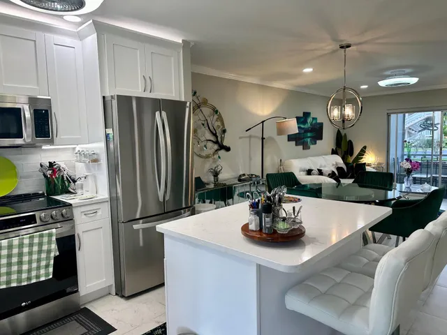 a kitchen with a refrigerator and a sink