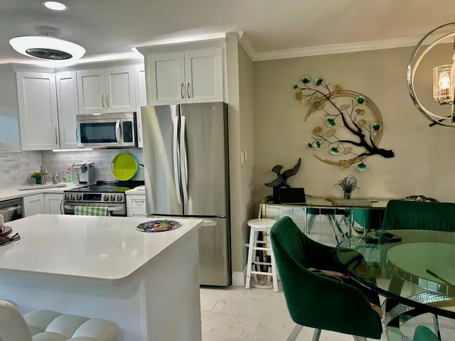 a kitchen with a sink cabinets and stainless steel appliances