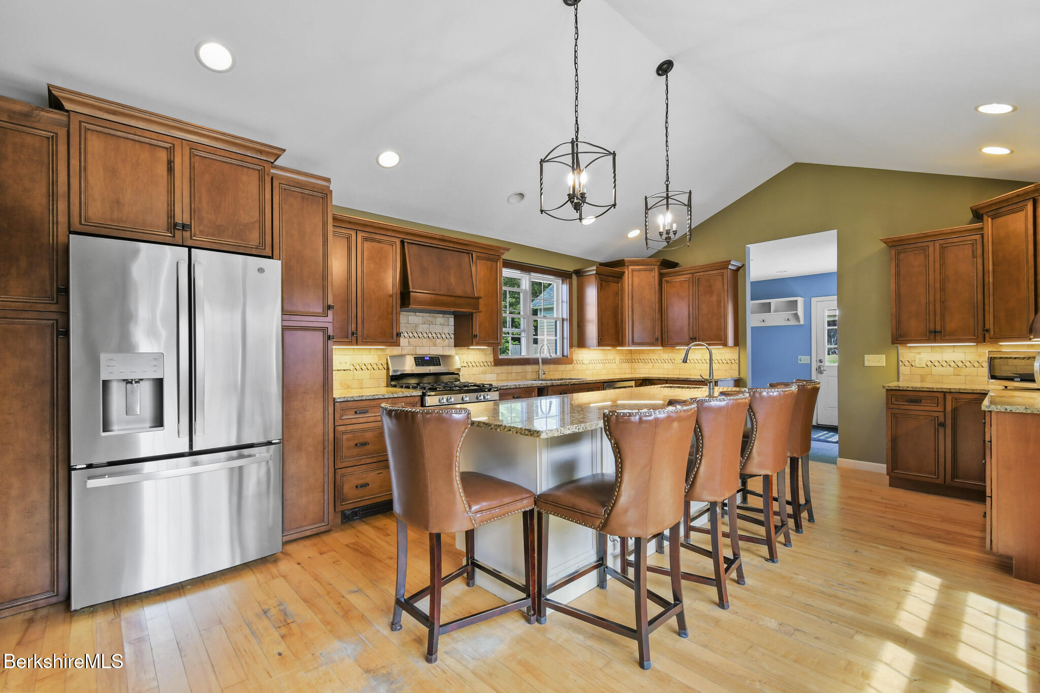 165 High Street Dalton, MA 01226 - Photo 15 of 38 a kitchen with stainless steel appliances a dining table chairs refrigerator and microwave