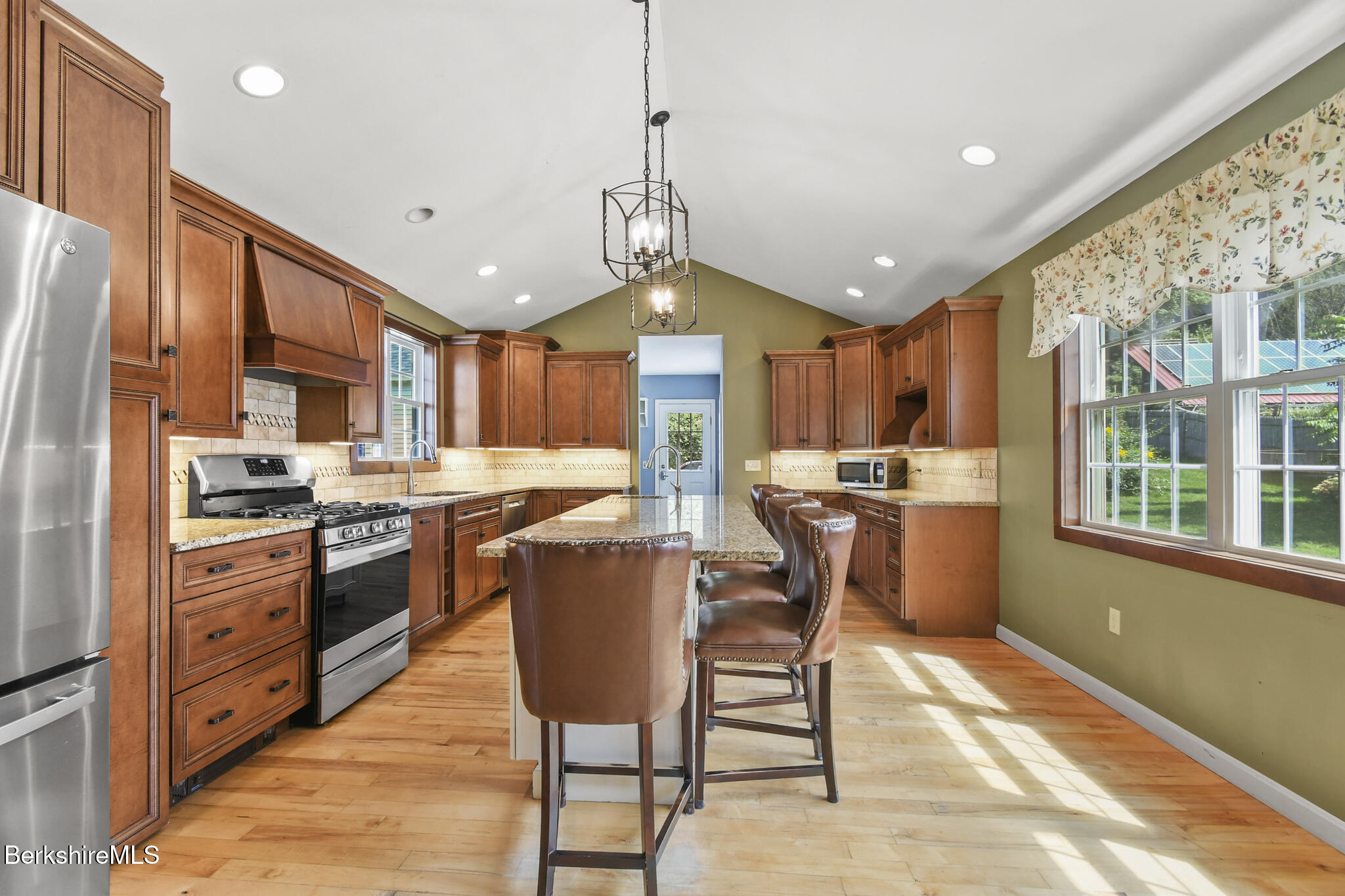 165 High Street Dalton, MA 01226 - Photo 18 of 38 a kitchen with stainless steel appliances granite countertop a stove top oven a refrigerator a sink dishwasher a dining table and chairs with wooden floor