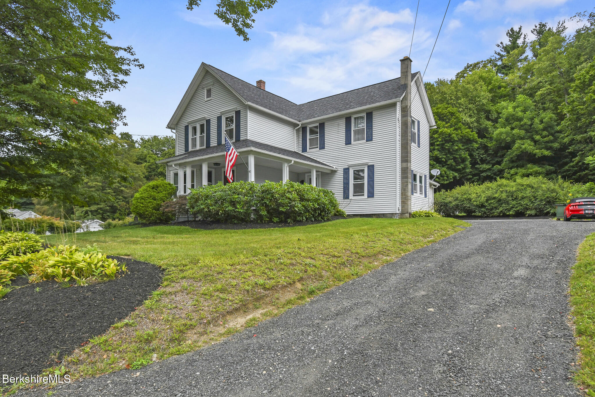 165 High Street Dalton, MA 01226 - Photo 2 of 38 a front view of a house with a garden