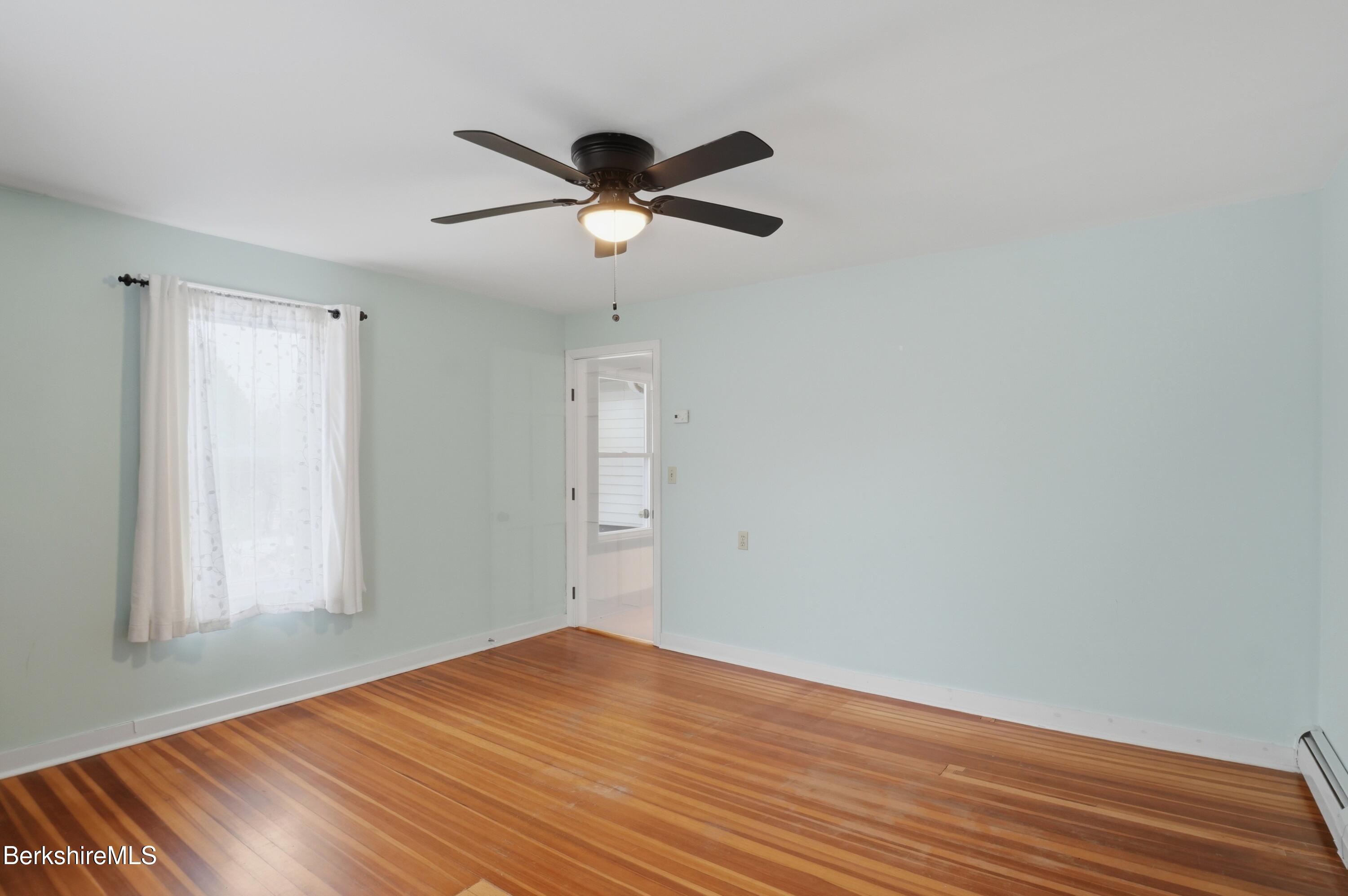 165 High Street Dalton, MA 01226 - Photo 21 of 38 a view of empty room with wooden floor and fan