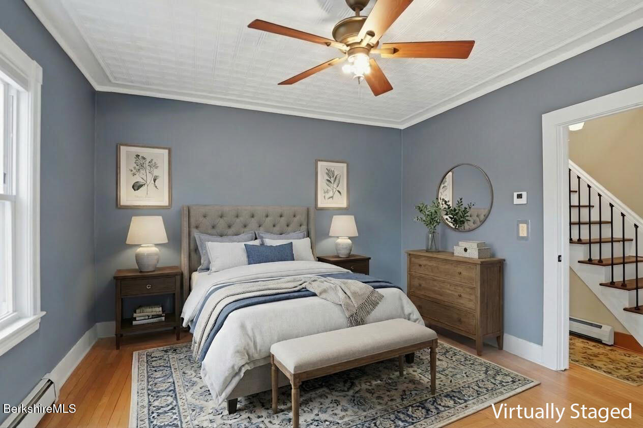 165 High Street Dalton, MA 01226 - Photo 8 of 38 a bedroom with a bed a chandelier and dresser