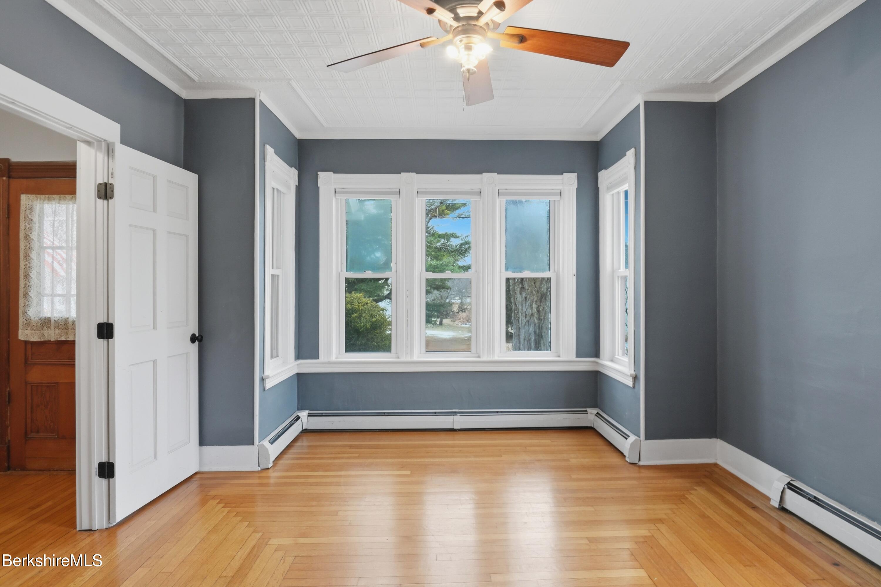 165 High Street Dalton, MA 01226 - Photo 9 of 38 a view of an empty room with window and wooden floor