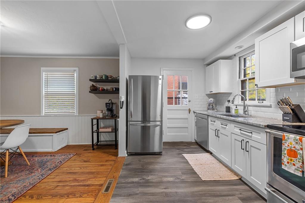 747 Fruithurst Drive Pittsburgh, PA 15228 - Photo 11 of 39 a kitchen with a refrigerator wooden floor a dining table and chairs