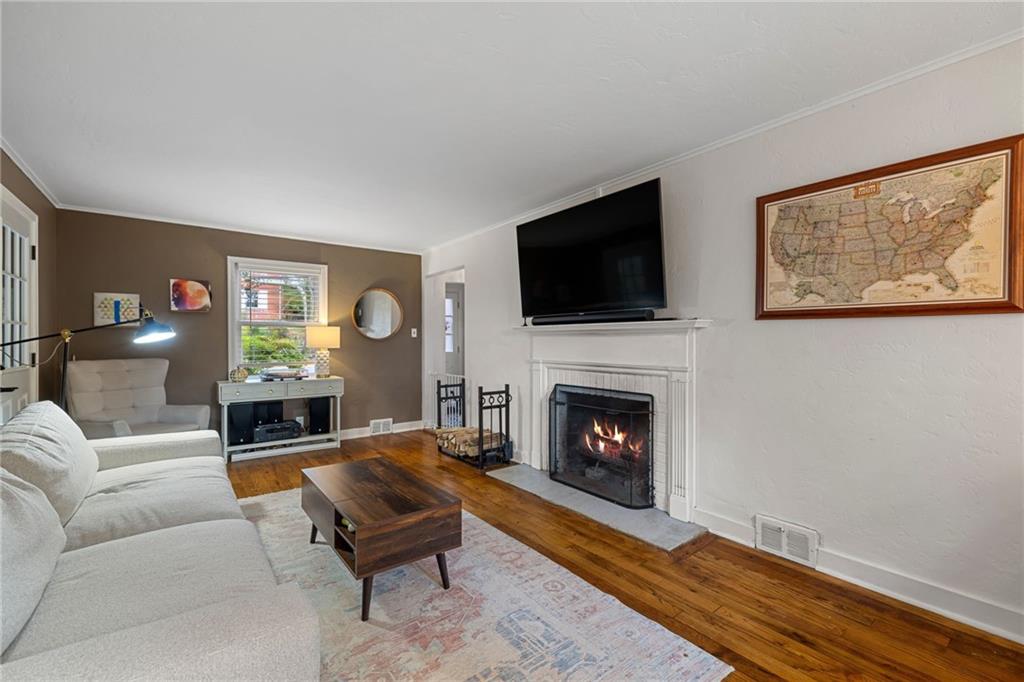 747 Fruithurst Drive Pittsburgh, PA 15228 - Photo 12 of 39 a living room with furniture a flat screen tv and a fireplace