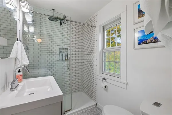 a bathroom with a sink a toilet and shower curtain
