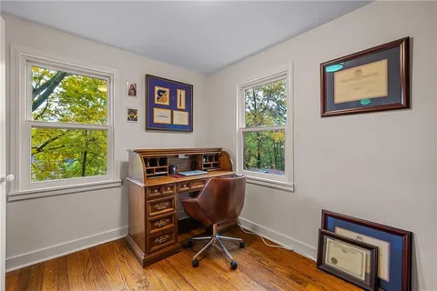 a workspace with wooden floor and a window