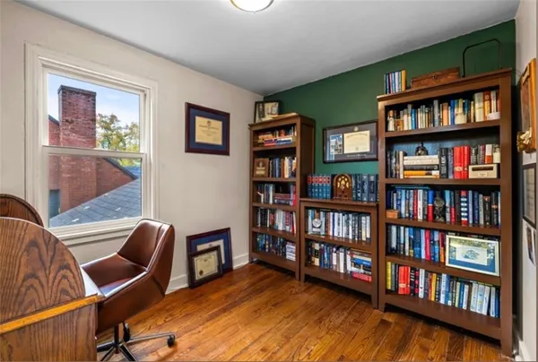 a view of a livingroom with furniture bookshelf and a window