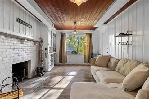 a living room with furniture a fireplace and a chandelier