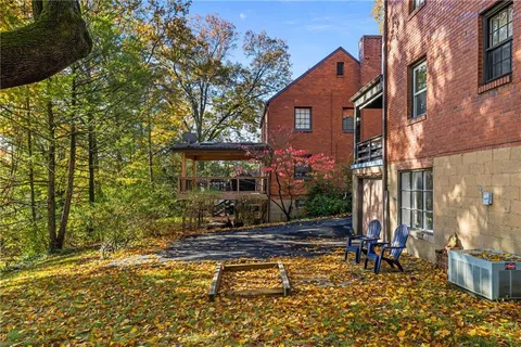 a view of a house with a tree in the yard