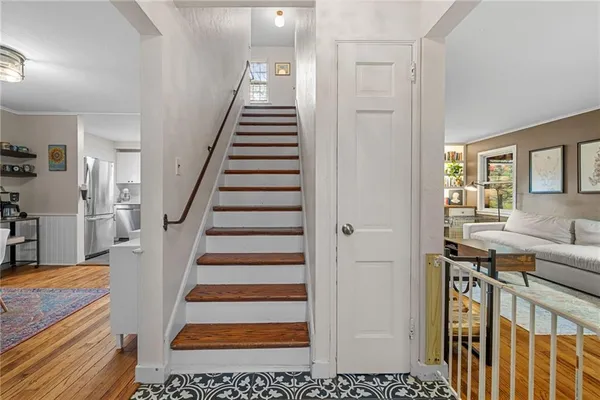 a view of entryway and hall with wooden floor