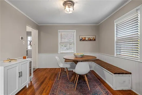 a view of a workspace with furniture and wooden floor
