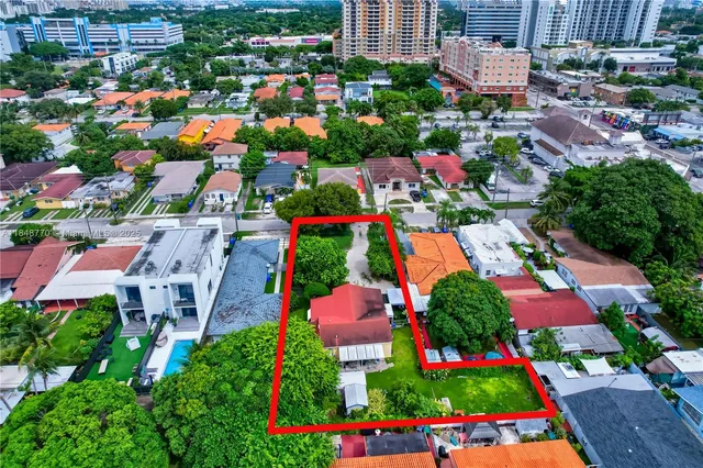 a front view of a house with a yard and a garage