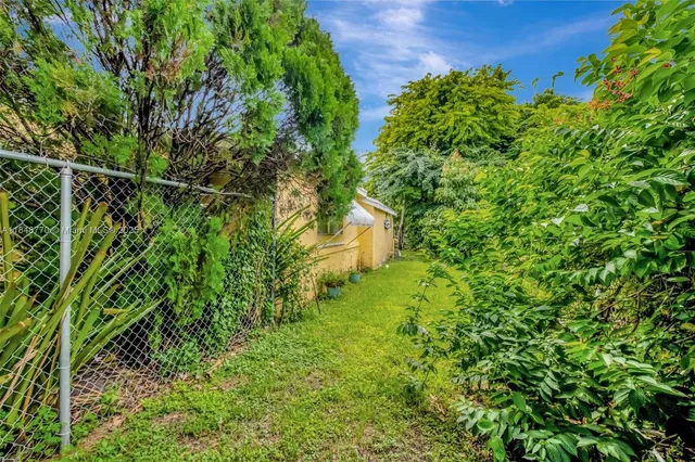 a view of a garden with an outdoor seating