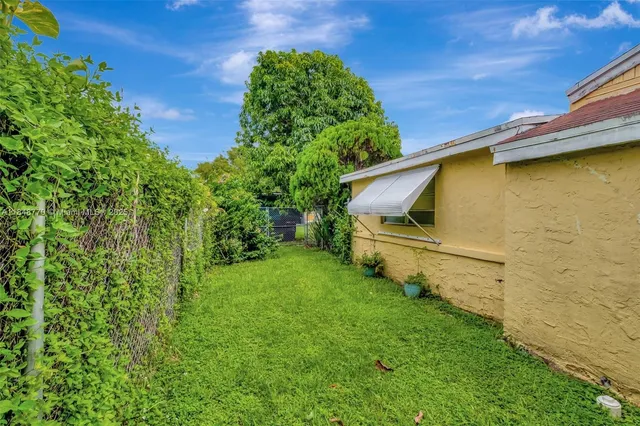 a view of a house with a yard patio and slide