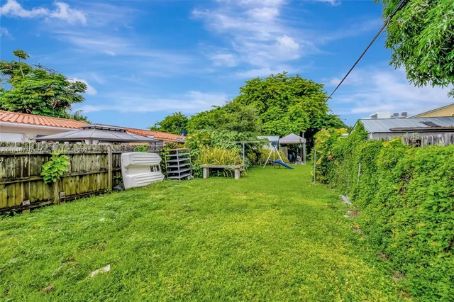 a view of a patio with chairs and plants