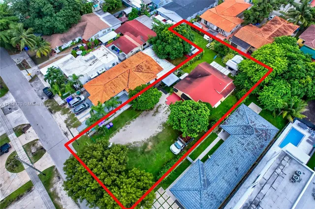 an aerial view of residential houses with outdoor space and street view