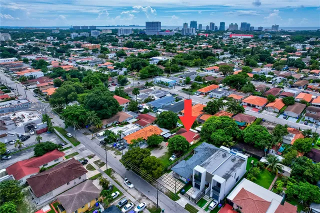 an aerial view of multiple houses with yard