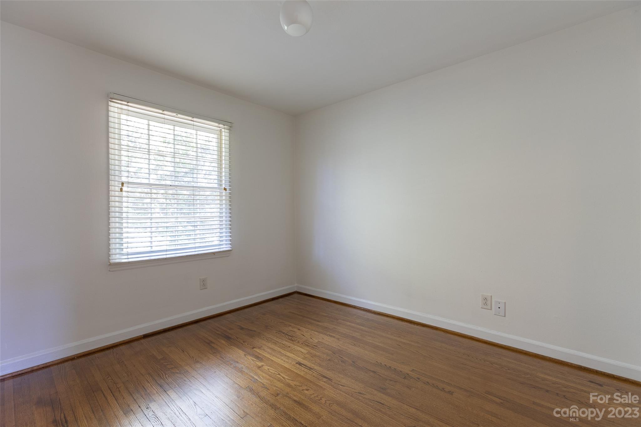 4319 Walker Road, Unit C Charlotte, NC 28211 - Photo 11 of 13 an empty room with wooden floor and windows