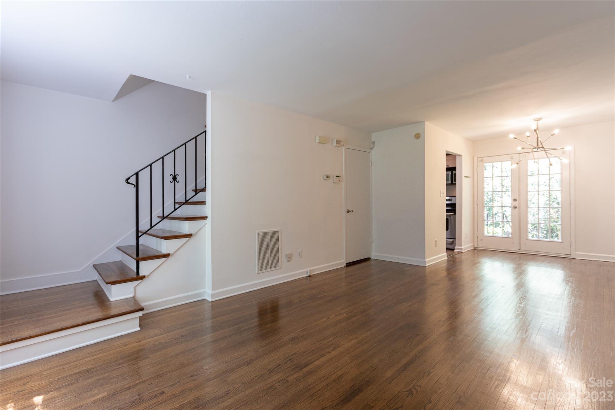 4319 Walker Road, Unit C Charlotte, NC 28211 - Photo 3 of 13 a view of an empty room with wooden floor and a window