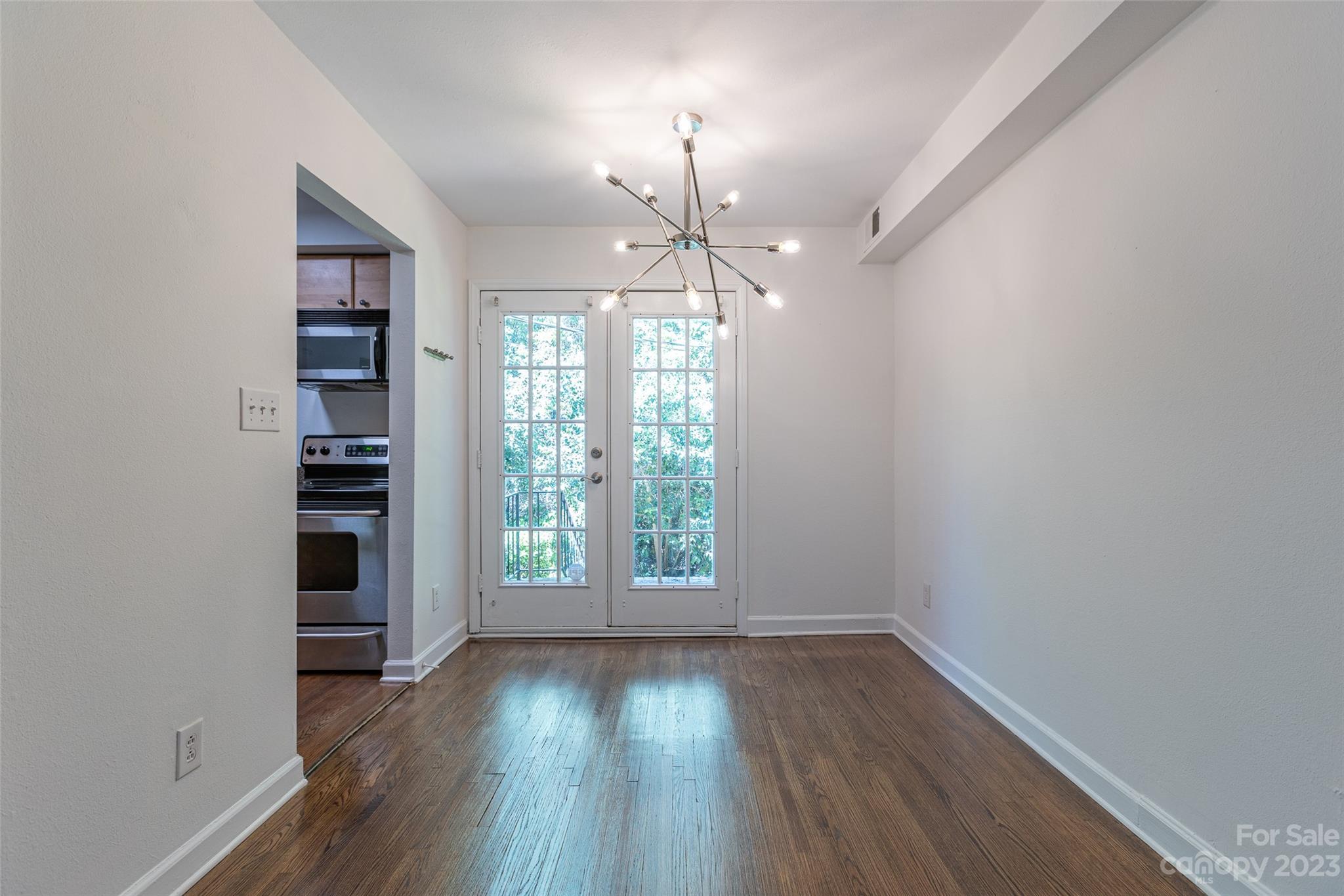 4319 Walker Road, Unit C Charlotte, NC 28211 - Photo 4 of 13 wooden floor in an empty room with a window