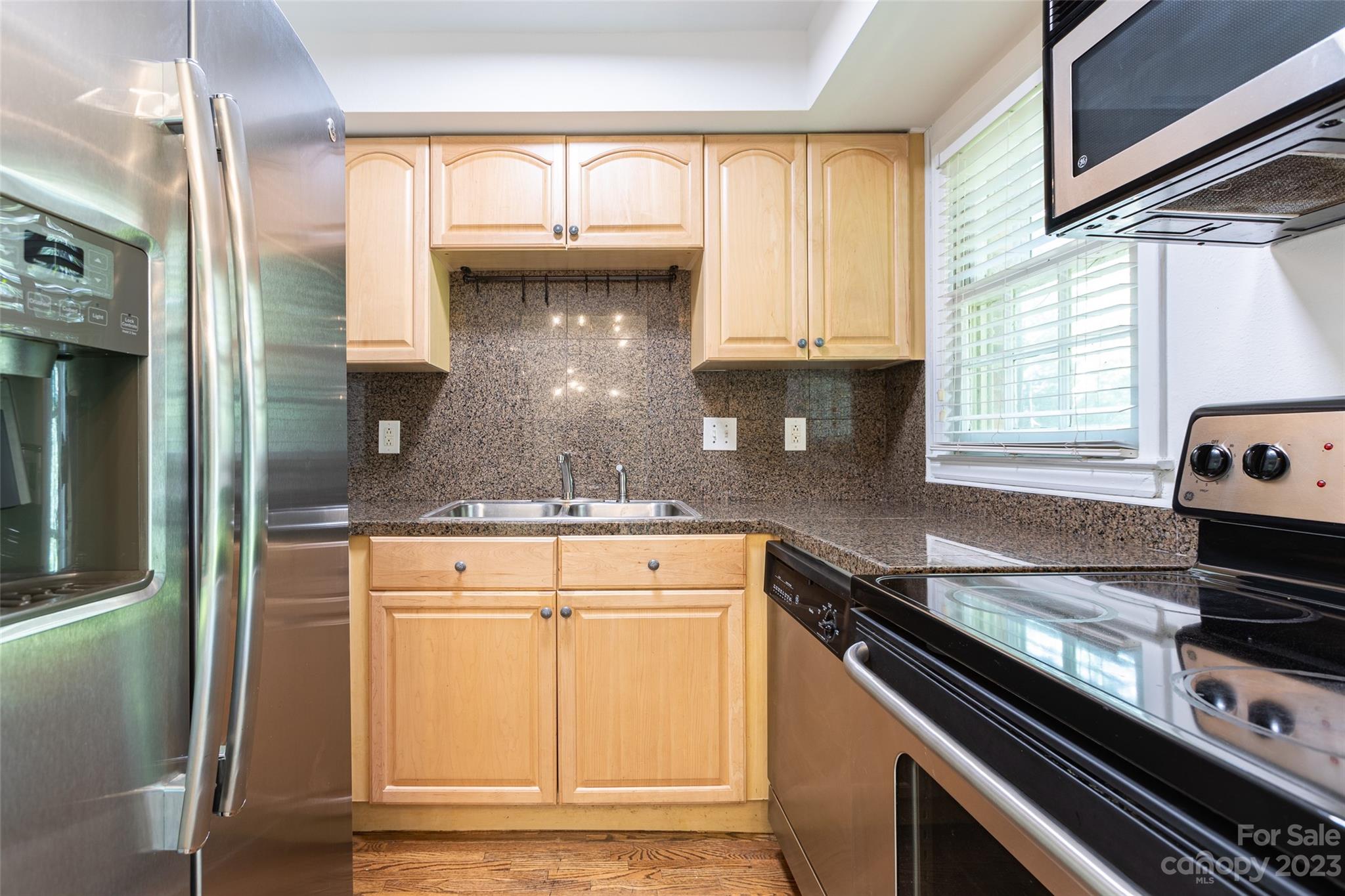 4319 Walker Road, Unit C Charlotte, NC 28211 - Photo 6 of 13 a kitchen with stainless steel appliances granite countertop a stove and a refrigerator