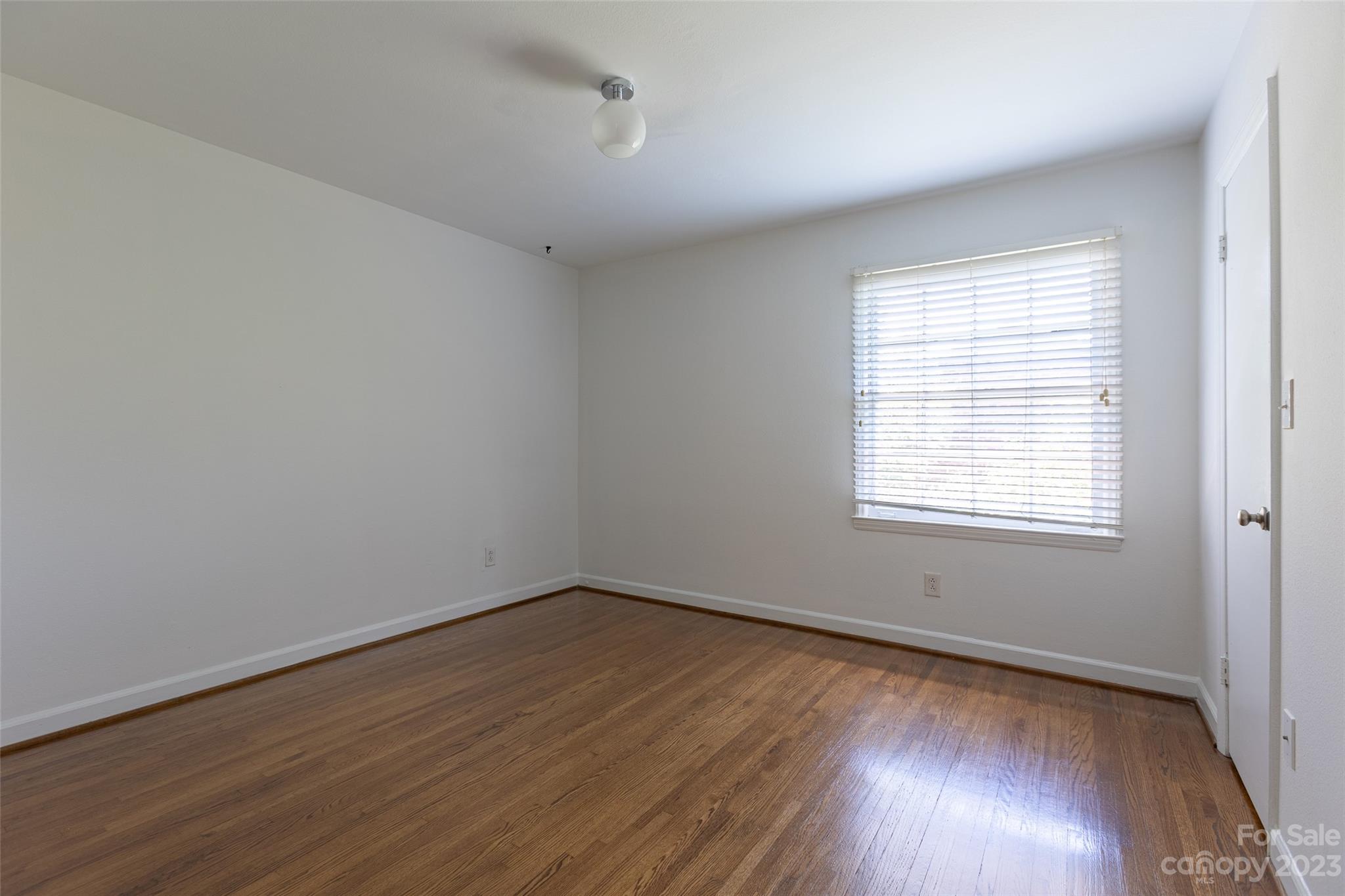 4319 Walker Road, Unit C Charlotte, NC 28211 - Photo 9 of 13 wooden floor in an empty room with a window