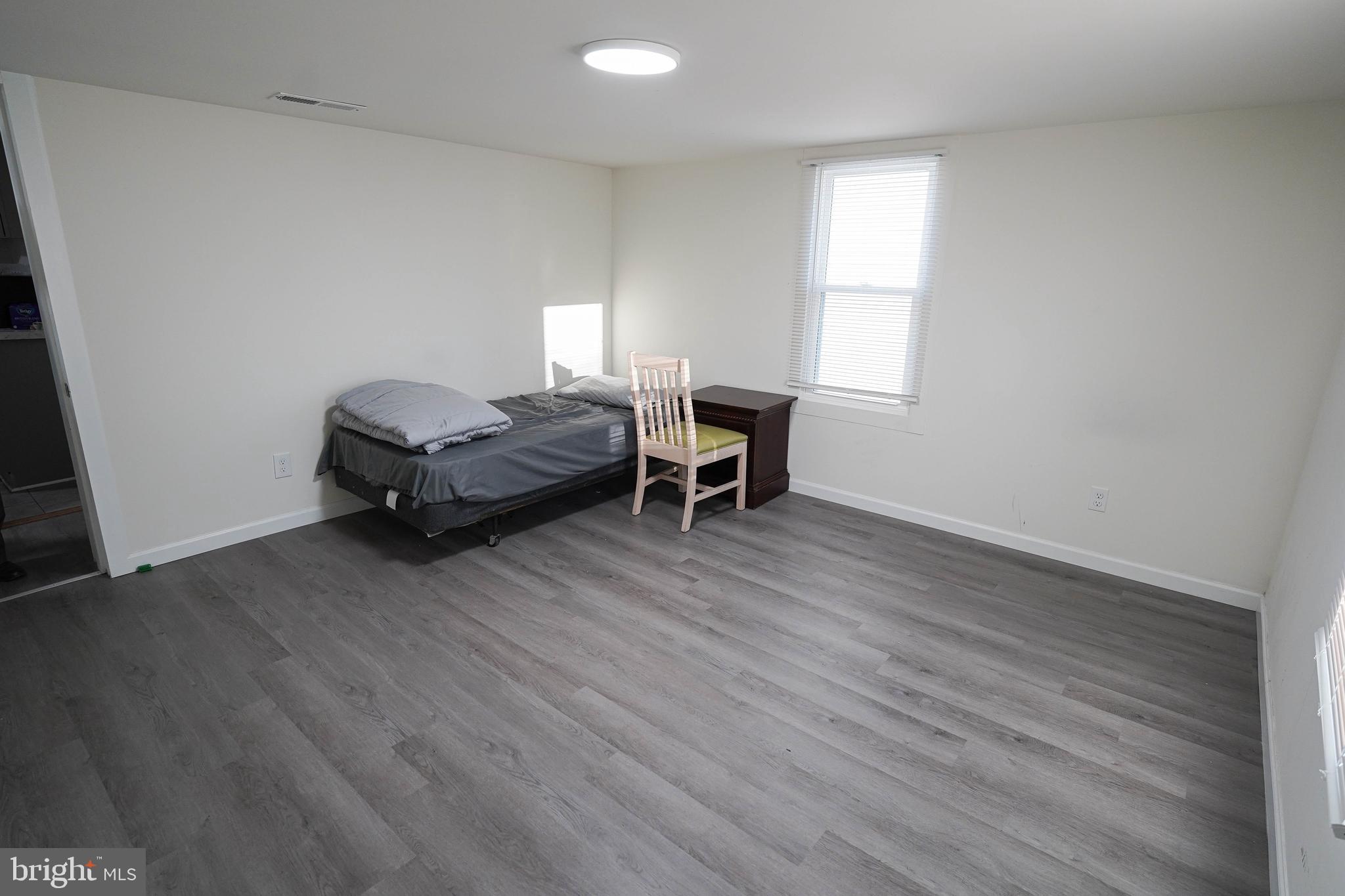 231 Newton Street, Unit B Salisbury, MD 21801 - Photo 15 of 31 a living room with furniture and a wooden floor